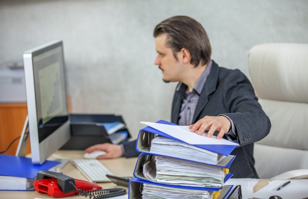 Young businessman working from his office - the concept of hard work